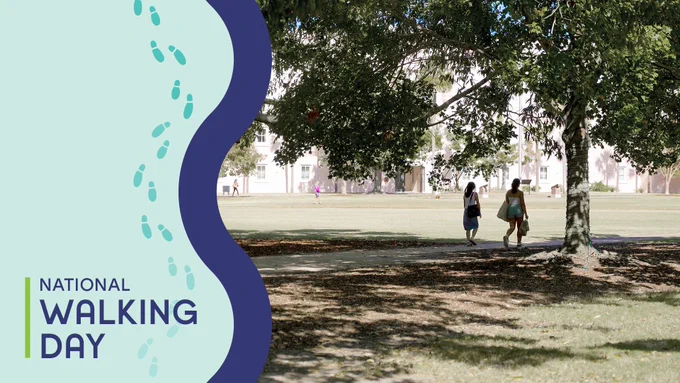 Two women walking in a park with the text "National Walking Day" and walking feet icons.