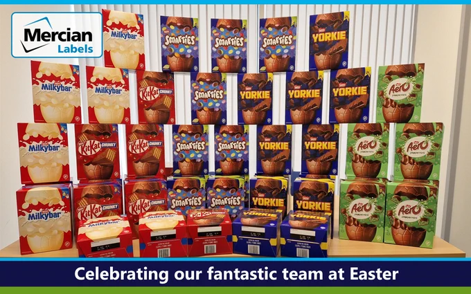 A display of various Nestle chocolate Easter eggs arranged on a table, including Milky Bar, KitKat, Smarties, Yorkie and peppermint Aero. Text across the base reads "Celebrating our fantastic team at Easter" and the Mercian Labels logo appears at the top left.