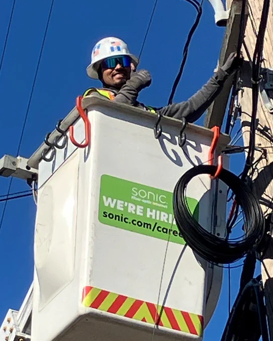 Manny, a Field Service Operator with Sonic, is throwing a thumbs-up from the bucket on his bucket truck to all of our amazing members! 