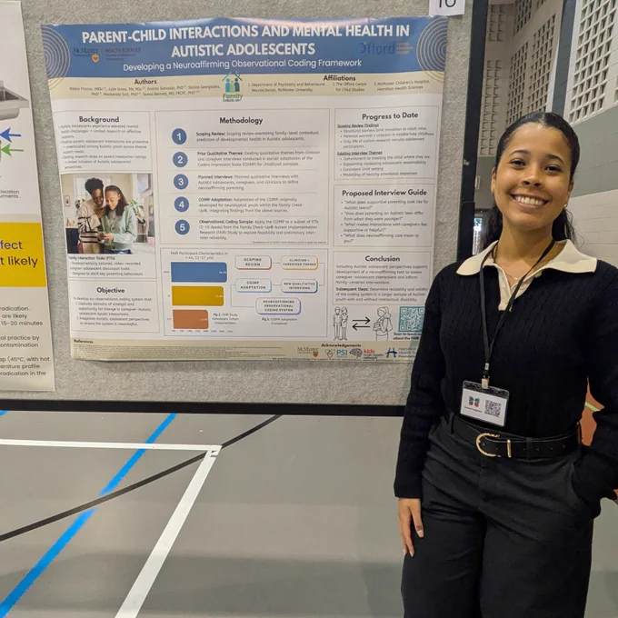 Kaela Franco stands and smiles with a poster titled, "Parent-Child Interactions and Mental Health in Autistic Adolescents".