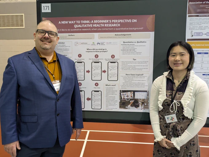 Dr. Mackenzie Salt and Ling Shan Zhang stand and smile with a poster titled, "A New Way to Think: A Beginner's Perspective on Qualitative Health Research".
