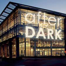 Illustration shows the exterior of Cabell Library at night. The words "after dark" are superimposed on the image. 