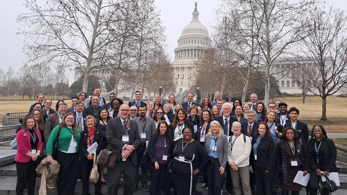 ASBMB staff Lynn Marquis, Raechel McKinley and Shannon Freedman pose for a photo with ASBMB committee members, fellows, delegates from the Advocacy Training Program and other ASBMB members in front of the U.S. Capitol building in Washington, D.C.