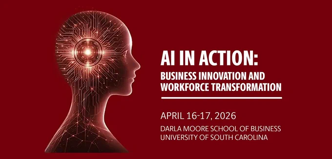 Banner with a USC garnet colored background featuring a stylized side profile of a human head on the left, rendered in glowing circuitry patterns with a bright light at the center of the brain, suggesting artificial intelligence. On the right, bold white text reads: “AI IN ACTION: Business Innovation and Workforce Transformation.” Below, smaller text states the event dates, “April 16–17, 2026,” and the location: “Darla Moore School of Business, University of South Carolina.” The overall design emphasizes technology, innovation, and a professional academic conference theme.