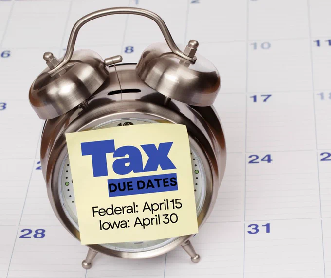 repeating the tax deadlines for federal and state on top of a calendar with an alarm bell.