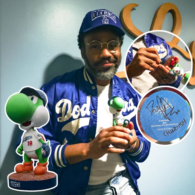 Donald Glover poses holding an autographed Yoshi bobblehead