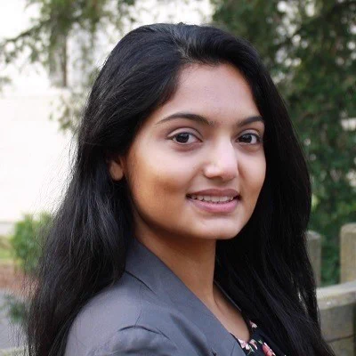 Devi Jayakrishnan smiling.