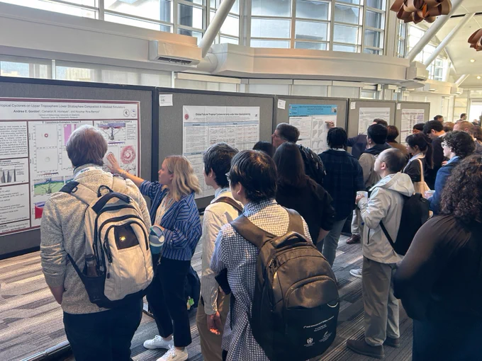 Attendees looking at posters during poster session.