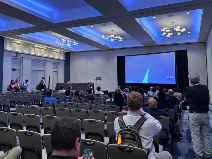 Attendees gathering in a session room to watch the Artemis launch.