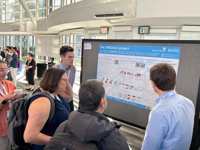 Attendees looking at a poster.