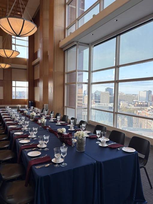 Formally set dining table with a city view of Philadelphia