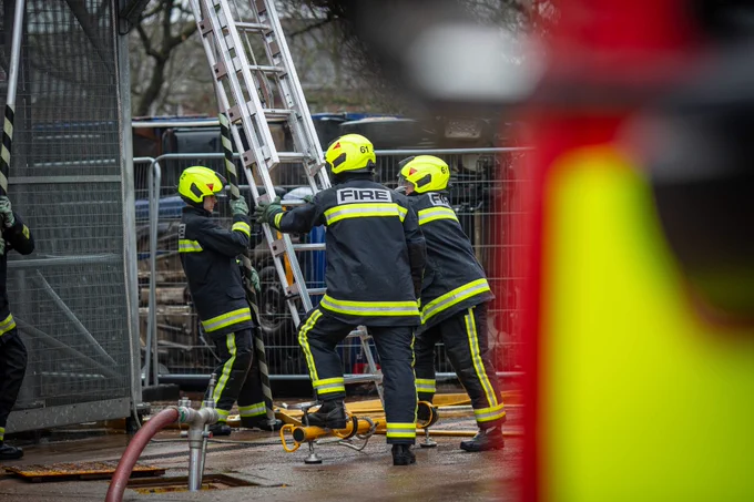 Firefighters putting up a ladder