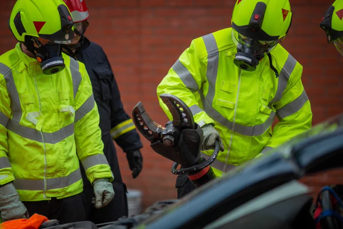Firefighters practising with hydraulic rescue equipment