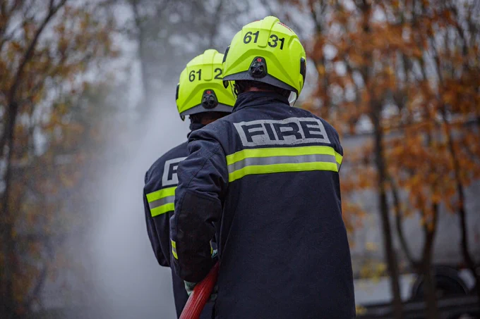 Firefighters practising with a hose reel jet