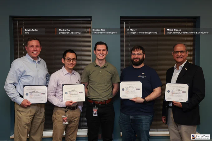 Leadership and engineering team members at LayerZero Power Systems gather during ESGR Patriot Award recognition honoring workplace support for military service. From left to right: Patrick Taylor, Chief Executive Officer; Shujing Zhu, Director of Engineering; Brandon Pike, Software Security Engineer and National Guard member whose nomination led to the recognition; PJ Morley, Manager – Software Engineering I; and Milind Bhanoo, Vice Chairman, Board Member, and Co-founder. LayerZero team members shown holding certificates were recognized through the Employer Support of the Guard and Reserve Patriot Award for supporting employees serving in the National Guard and Reserve.