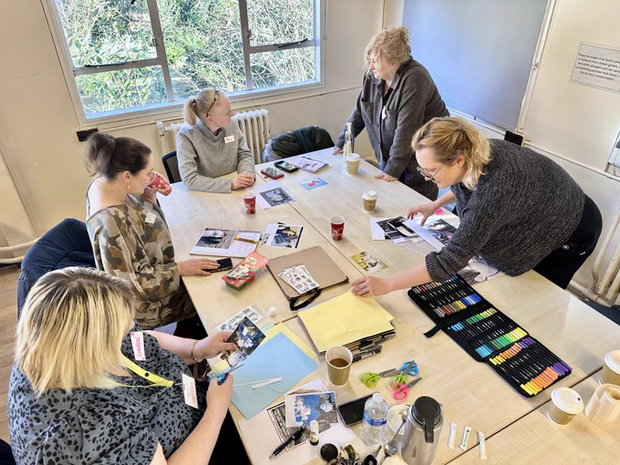 Photo of previous group Living Memory activity showing people crafting at a table
