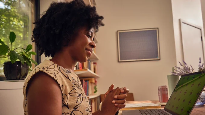 An online therapist looking at their laptop.