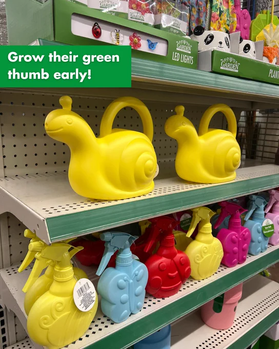 Bright yellow snail-shaped watering cans displayed on a store shelf alongside colorful spray bottles shaped like ladybugs and snails. Text on the screen reads "Grow their green thumb early."