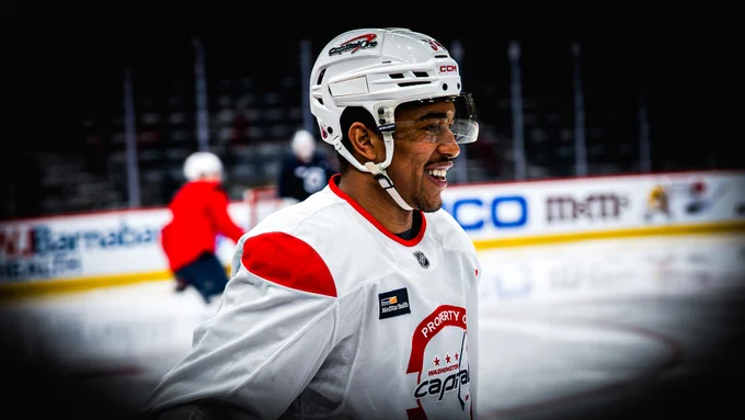 Justin Sourdif skates by the bench with a smile on his face.