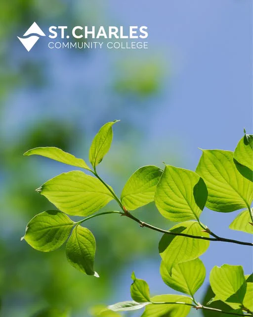 A branch with bright green leaves against a clear blue sky. The logo and text "St. Charles Community College" are in the top left corner.