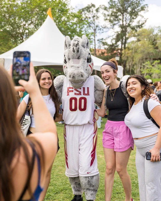 Students smile and pose with cimarron