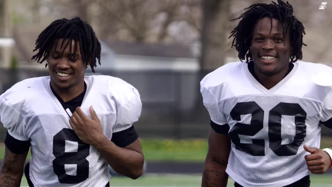 Players run off the field smiling.