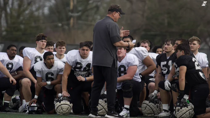 Coach Keevers commands attention from the team.