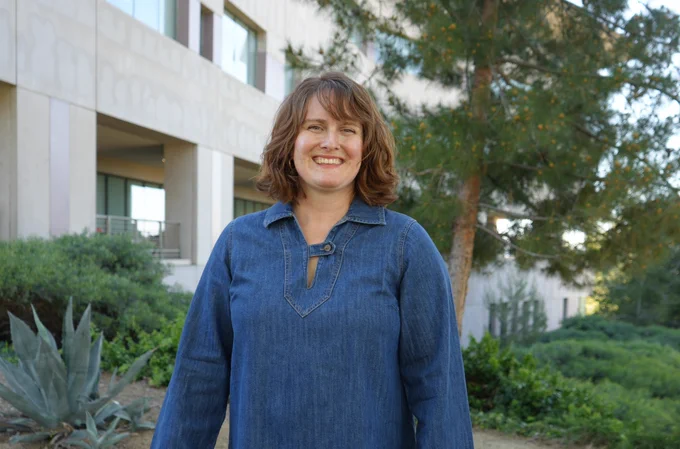 Person standing outside the Kellogg Library building