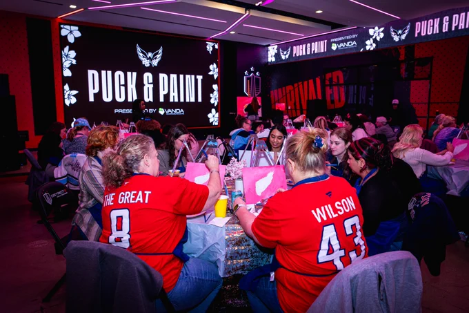 A wide photo of tonight's Puck & Paint event at District E.