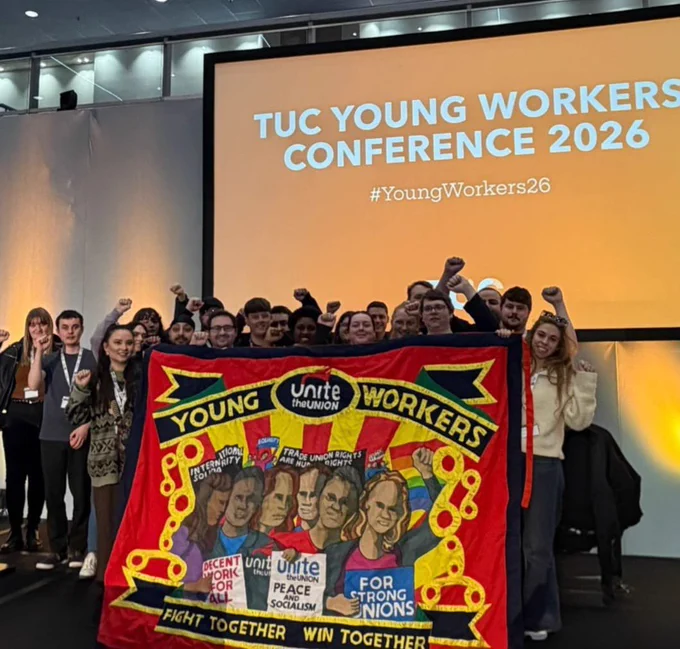 Image of the Unite Young Members delegation at TUC Young Workers Conference standing behind a banner reading “Young Workers Unite the Union - Fight Together, Win Together”