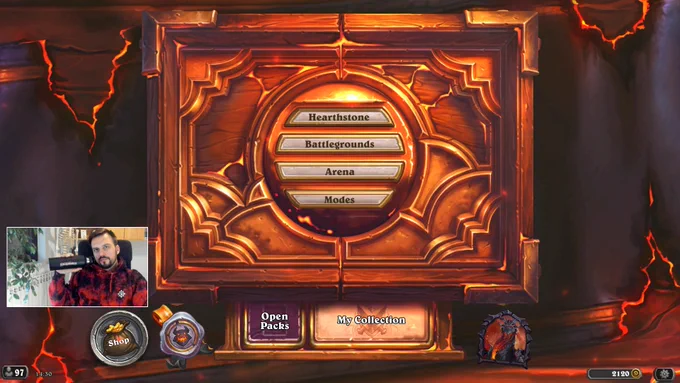 Screenshot from reqvam's stream where he is wearing a Hearthstone CATACLYSM themed hoodie and holding a Hearthstone water bottle.