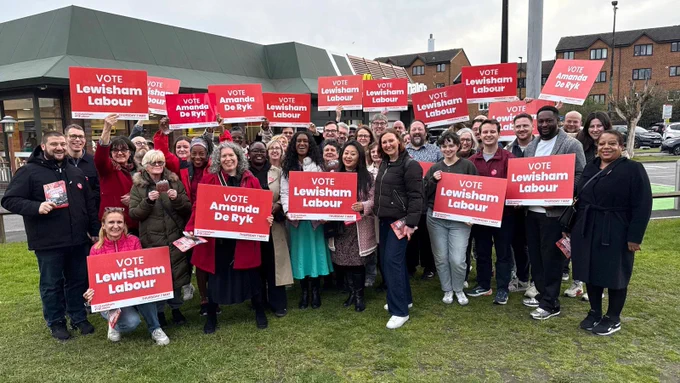 Large group of activists, councillors, candidates gathered to support Lewisham Labour - lots of red banners saying Vote Amanda De Ryk and Vote Lewisham Labour