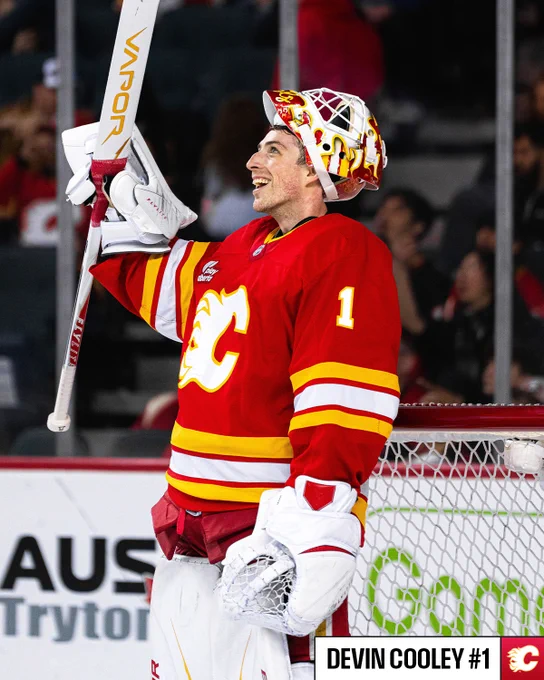 Photo of Devin Cooley in a Calgary Flames uniform watching the jumbotron