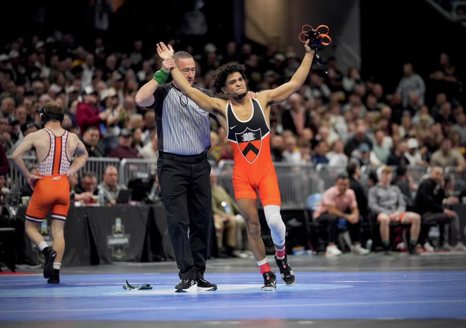 McGowan raises arms as he wins quarterfinal match.