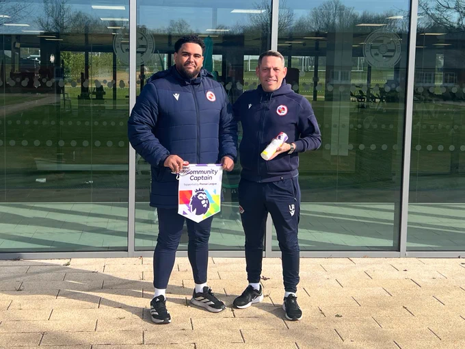 Ryan Robinson receiving his Community Champion Award from Reading FC Manager Leam Richardson