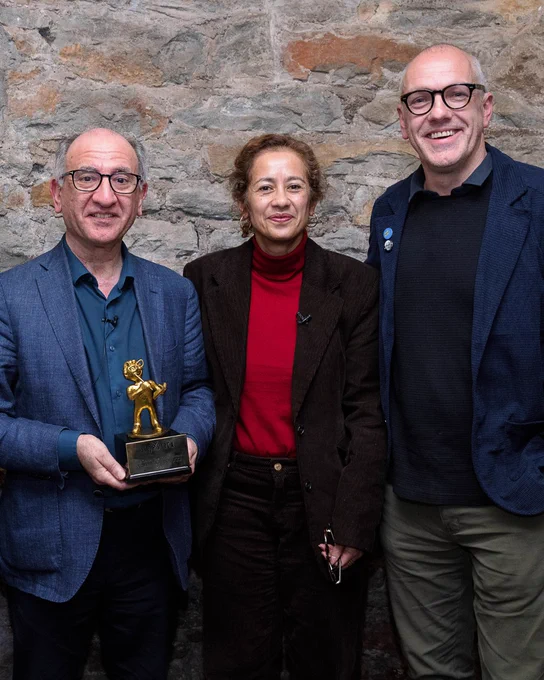 Armando Iannucci holding his Golden Baz Award with Samira Ahmed and Bob Cryer