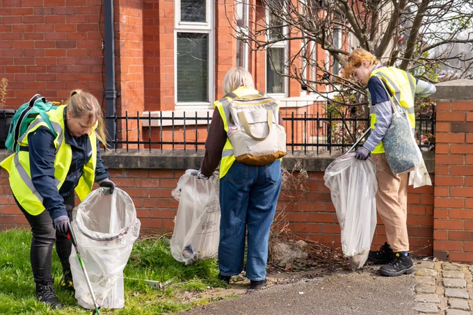 An image showing volunteers taking part in litter picking as part of the Great British Spring Clean campaign in South Manchester.