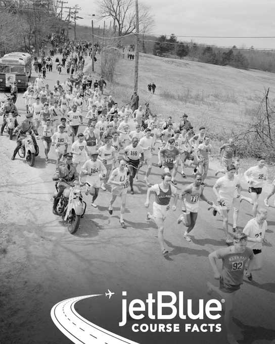 Vintage black and white photo of participants running the Boston Marathon near the start