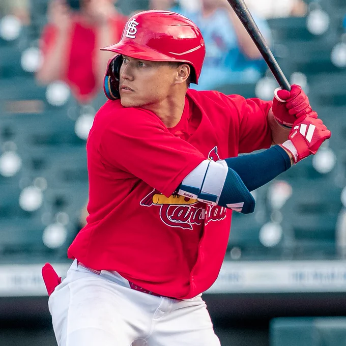 JJ Wetherholt batting in a red Cardinals jersey and grey pants