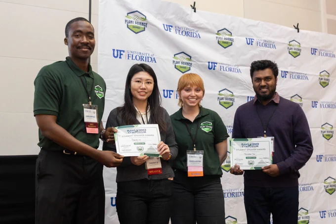 Ph.D. candidate Mohammad Monirul Hasan Tipu (right) holding a student speaker award at the University of Florida Plant Science Symposium.
