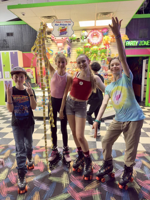Students post with arcade game tickets