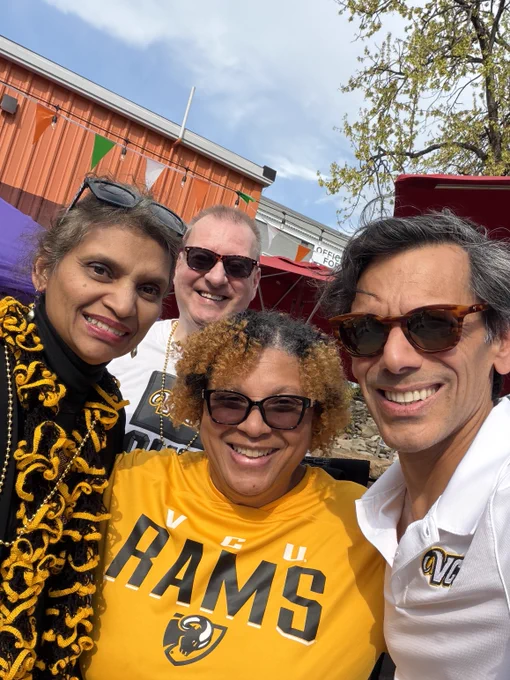 Selfie of Dr. Rao and Monica Rao with a woman and a gentleman. The woman wears a gold V-C-U Rams shirt.