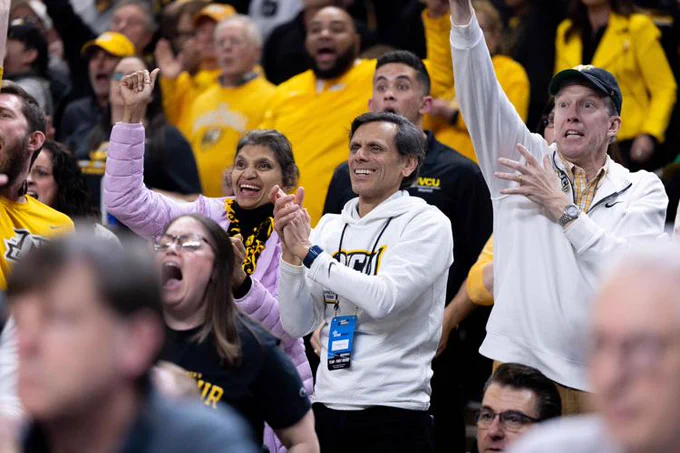 Dr. Rao and Monica Rao cheering in the stands.