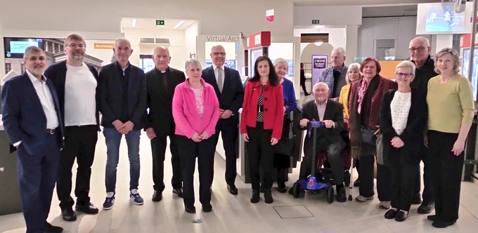 Group of people standing by an exhibition 