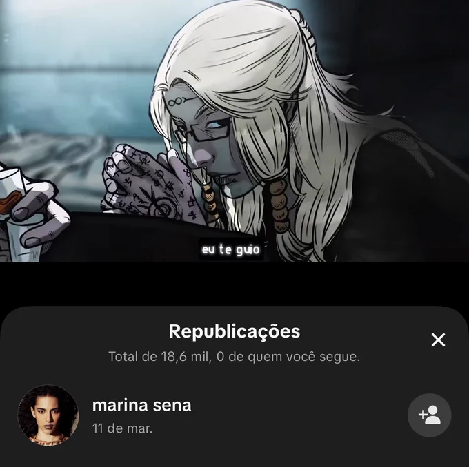 Captura de tela do aplicativo TikTok. Em cima vemos uma ilustração do Dante, homem branco de cabelos loiros longos, ele está com as mãos juntas em posição de reza. Em baixo se lê “eu te guio”. Mais abaixo, se lê “Republicações, total de 18,6 mil, 0 de quem você segue.”. Por fim, o ícone da Marina Sena, uma mulher branca de cabelos escuros e longos, e do lado se lê “marina sena, 11 de mar.”.