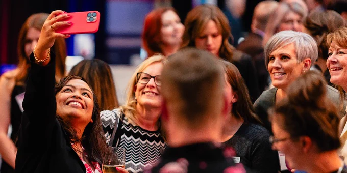 A group of people are posing for a selfie.