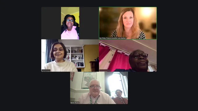 A virtual meeting on a video call platform showing five participants in a grid layout. Four women and one man are visible. Participants appear in home or office settings, including bookshelves, curtains, and a softly blurred background. At the bottom, a man sits in an office with another person behind him.