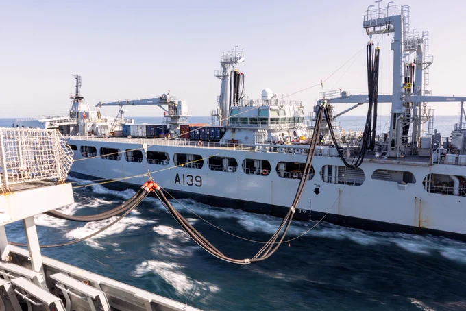 HMS Dragon takes on supplies during her voyage to Cyprus