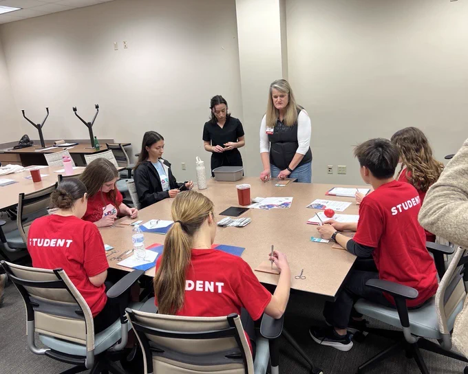 Dr. Wilke teaches suturing skills to students