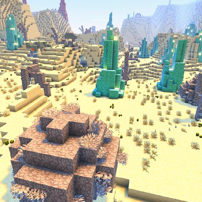 A Minecraft scene of a desert wasteland with Prismarine and dried coral structures emerging from the ground.